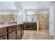 The bathroom features tiled floors, large mirror over double vanity, and a glass-enclosed shower at 3131 Bass Boat Way, Kissimmee, FL 34746