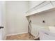 This laundry room features white walls, tiled floors, utility sink, and wire shelving at 3131 Bass Boat Way, Kissimmee, FL 34746