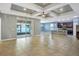 Open-concept living room and kitchen area with tile floors and a tray ceiling with fan at 3131 Bass Boat Way, Kissimmee, FL 34746