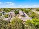 Aerial community view of townhouses, buildings, and lush greenery on a bright sunny day at 3161 Britannia Blvd # A, Kissimmee, FL 34747