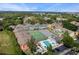 A sunny aerial view of the community's pool, tennis court, and playground at 3161 Britannia Blvd # A, Kissimmee, FL 34747