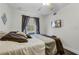 Relaxing bedroom with a large window, ceiling fan, and a mounted television at 3161 Britannia Blvd # A, Kissimmee, FL 34747