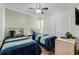 Bright bedroom with two twin beds, ceiling fan, tile floors, and closet space at 3161 Britannia Blvd # A, Kissimmee, FL 34747