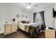Cozy bedroom featuring ceiling fan, comfortable bed, and ample natural light at 3161 Britannia Blvd # A, Kissimmee, FL 34747