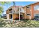 Back exterior view of a two-story multi-Gathering unit with patios, balconies, and exterior stairs at 3161 Britannia Blvd # A, Kissimmee, FL 34747