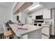 Bright kitchen features white cabinets and appliances, with a cozy breakfast bar for casual dining at 3161 Britannia Blvd # A, Kissimmee, FL 34747
