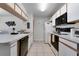 Functional kitchen featuring ample countertop space and modern appliances, including a dishwasher at 3161 Britannia Blvd # A, Kissimmee, FL 34747