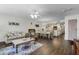 Open-concept living room and dining area with hardwood floors and a neutral color palette at 3161 Britannia Blvd # A, Kissimmee, FL 34747