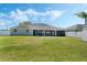 Spacious backyard featuring a covered patio, well-maintained lawn, and fenced perimeter for added privacy at 3263 Lorimar Ln, St Cloud, FL 34772