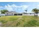 Expansive backyard showcasing a lush green lawn, storage shed, and secure white picket fence at 3263 Lorimar Ln, St Cloud, FL 34772