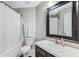 This bathroom features a shower and a large framed mirror above the sink at 3263 Lorimar Ln, St Cloud, FL 34772