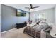 Well-lit bedroom featuring carpeted floors, a ceiling fan, and a large window overlooking the yard at 3263 Lorimar Ln, St Cloud, FL 34772