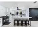 Bright kitchen boasts white cabinets, a center island, and a contrasting black accent wall at 3263 Lorimar Ln, St Cloud, FL 34772
