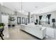 Spacious living room with neutral tones, white leather furniture, and tile flooring at 3263 Lorimar Ln, St Cloud, FL 34772