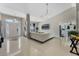 Open concept living room showcasing tiled floors, white walls, and ample natural light at 3263 Lorimar Ln, St Cloud, FL 34772