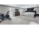 Large primary bedroom featuring a tray ceiling, carpet flooring, and an adjacent bathroom at 3263 Lorimar Ln, St Cloud, FL 34772