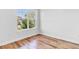 A bedroom with wood-look floors and a window, providing a simple and comfortable living space at 362 Villa Sorrento Cir, Haines City, FL 33844