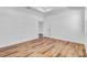 Bright bedroom featuring wood-look floors, white walls and an open doorway leading to another room at 362 Villa Sorrento Cir, Haines City, FL 33844