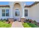 Welcoming front door entrance with brick-paved pathway, stone accents, and lush landscaping at 362 Villa Sorrento Cir, Haines City, FL 33844