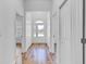 Bright hallway featuring wood-look floors, white walls and an entry door with frosted windows at 362 Villa Sorrento Cir, Haines City, FL 33844