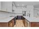 Modern kitchen showcasing two-tone cabinets, stainless steel appliances, and quartz countertops at 362 Villa Sorrento Cir, Haines City, FL 33844