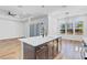 Contemporary kitchen island featuring a stainless steel dishwasher, a sink, and wood flooring at 362 Villa Sorrento Cir, Haines City, FL 33844