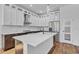 Bright kitchen with white cabinets, a stainless steel refrigerator, and quartz countertops at 362 Villa Sorrento Cir, Haines City, FL 33844