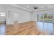 Open-concept living room features wood flooring, a fan, and access to the outdoor patio and pool at 362 Villa Sorrento Cir, Haines City, FL 33844