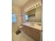Bathroom featuring a large mirror and vanity with white countertop at 366 Jaybee Ave, Davenport, FL 33897