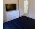 Neutral bedroom with a television on white dresser and a blue comforter on the bed at 366 Jaybee Ave, Davenport, FL 33897
