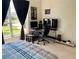 Spacious bedroom featuring a gaming setup, natural light, and neutral carpet at 366 Jaybee Ave, Davenport, FL 33897