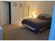 Bedroom with neutral carpet, queen bed, adjacent to the ensuite bathroom and closet at 366 Jaybee Ave, Davenport, FL 33897