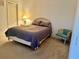 Bedroom with neutral carpet, queen bed, adjacent to the ensuite bathroom and closet at 366 Jaybee Ave, Davenport, FL 33897