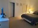 Bedroom with neutral carpet, queen bed, adjacent to the ensuite bathroom and closet at 366 Jaybee Ave, Davenport, FL 33897