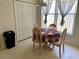 Cozy breakfast nook featuring a round table with four chairs near a large window and a pantry at 366 Jaybee Ave, Davenport, FL 33897