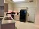 Functional kitchen with ample counter space, white cabinets, black appliances, and access to an exterior door at 366 Jaybee Ave, Davenport, FL 33897