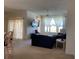 Bright living room with comfortable seating, a ceiling fan, and a view of an opening into the kitchen at 366 Jaybee Ave, Davenport, FL 33897
