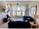 Cozy living room with large window, comfortable seating, a ceiling fan, and a wall-mounted TV at 366 Jaybee Ave, Davenport, FL 33897