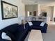 Bright living room with two black sofas, a decorative table, and an opening leading into the kitchen at 366 Jaybee Ave, Davenport, FL 33897