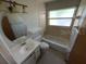 Bathroom featuring a white vanity, toilet, bathtub and shower combination, and a window for natural light at 4226 Lake Richmond Dr, Orlando, FL 32811
