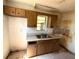 Kitchen with wooden cabinetry, a window over the sink, and ample counter space at 4226 Lake Richmond Dr, Orlando, FL 32811