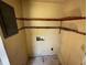 Small laundry room with upper shelving and access for washer and dryer hookups at 4226 Lake Richmond Dr, Orlando, FL 32811