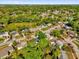 A scenic view showcases a neighborhood with lush greenery, mature trees and a glimpse of a serene lake in the distance at 4410 Rossmore Dr, Orlando, FL 32810
