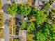 An overhead shot of a residential area with tree-lined streets and well-maintained properties showcasing lush landscaping at 4410 Rossmore Dr, Orlando, FL 32810