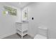 This bright bathroom has a modern vanity and mirror, updated toilet, and window for natural light at 4410 Rossmore Dr, Orlando, FL 32810