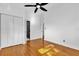 Well-lit bedroom features hardwood floors, closet, and an adjacent bathroom with a stand-up shower at 4410 Rossmore Dr, Orlando, FL 32810