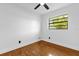 This bedroom features hardwood floors, a modern ceiling fan, and natural light from the window at 4410 Rossmore Dr, Orlando, FL 32810