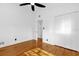 This bright bedroom features hardwood floors, a closet, and white walls and trim at 4410 Rossmore Dr, Orlando, FL 32810