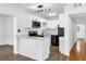 Modern kitchen with stainless steel appliances, white cabinets, and an adjacent dining area at 4410 Rossmore Dr, Orlando, FL 32810