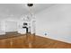 Bright living room with hardwood floors and modern lighting fixtures, flowing into the kitchen at 4410 Rossmore Dr, Orlando, FL 32810